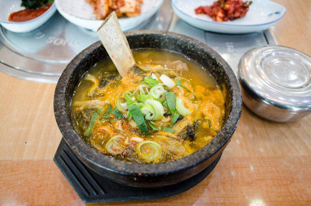 Bone broth is made by simmering animal bones, connective tissues, and sometimes vegetables for an extended period. T